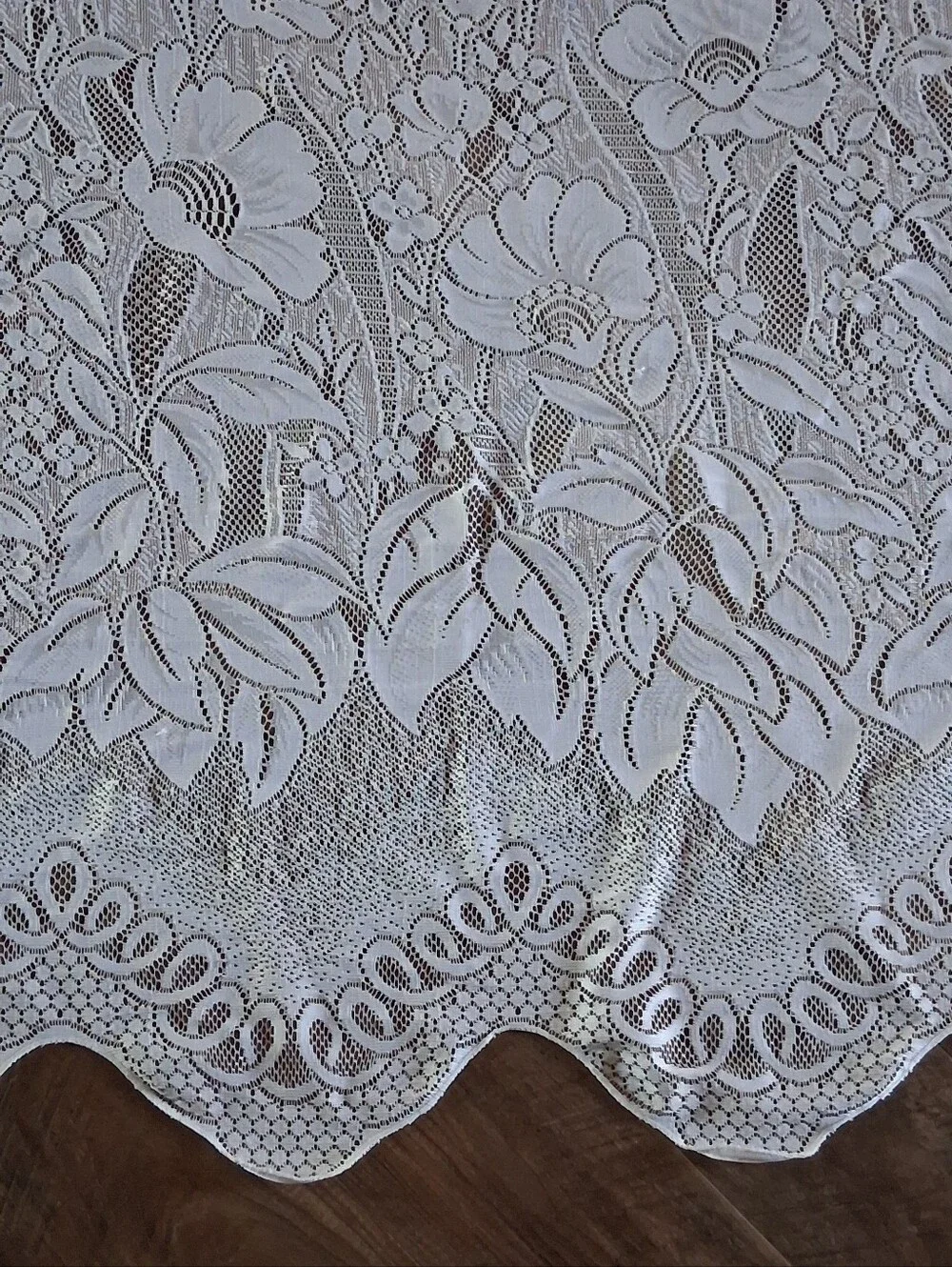 Vintage style floral lace curtain panel featuring an attached scalloped valance.